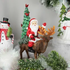 Outlet Santa Claus on a Reindeer Holding a Frosted Pine Tree Christmas Figurine - 8.25" Santa Claus